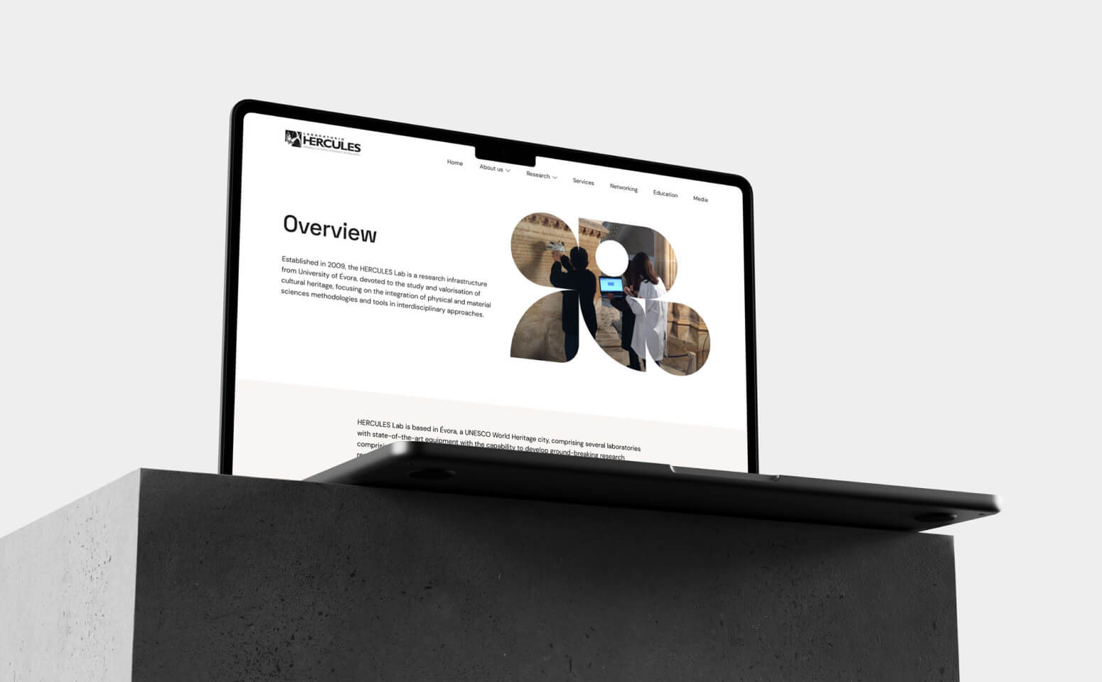 Desktop with HERCULES Lab website under concrete block.